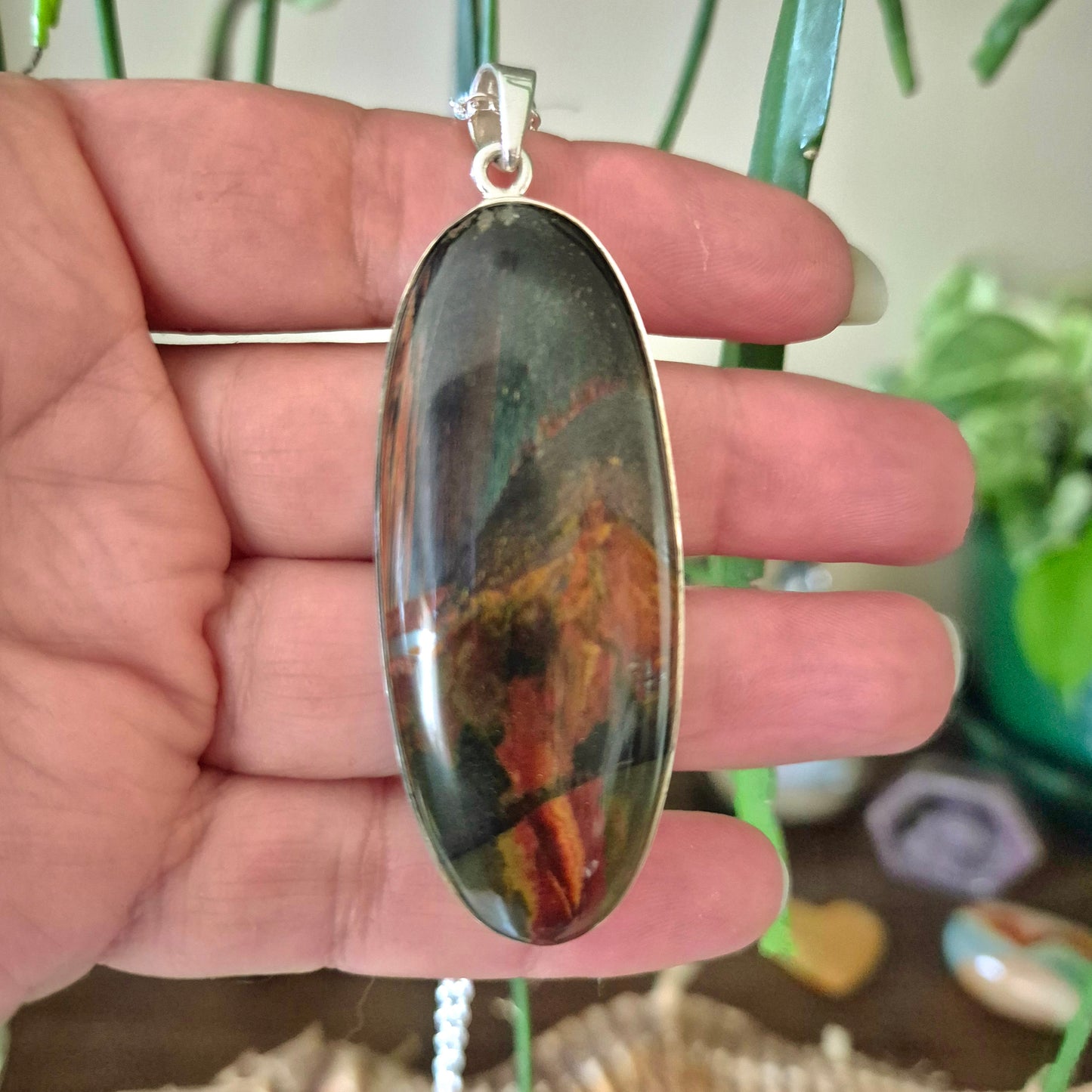 blue, red and gold tiger eye in oval pendant