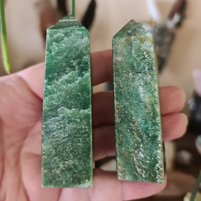 green crystal tower held in a hand