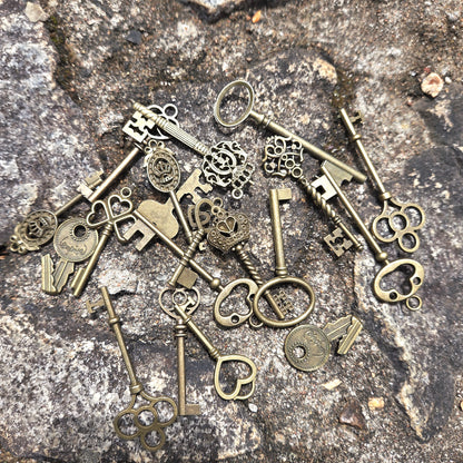 Collection of vintage-style bronze keys on a stone surface