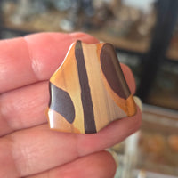 Wooden inlay on a hand with a blurred background