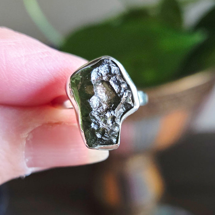 Silver ring with a natural stone on a blurred background