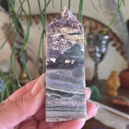 Person holding a crystal with a blurred background