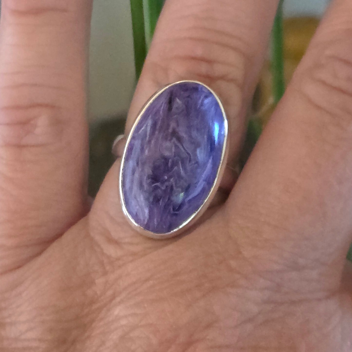 Ring with a purple stone on a person's finger
